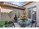 Charming patio area with fountain, table and chairs at 2223 W Hazelhurst Ct, Anthem, AZ 85086