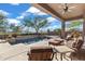 Relaxing pool area with patio furniture and mountain views at 2223 W Hazelhurst Ct, Anthem, AZ 85086