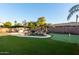 Landscaped backyard oasis with a pool, putting green and outdoor kitchen at 255 W Seagull Pl, Chandler, AZ 85286