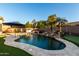 Refreshing kidney-shaped pool with a waterfall feature and putting green at 255 W Seagull Pl, Chandler, AZ 85286