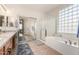 Elegant bathroom with granite countertops and a soaking tub at 255 W Seagull Pl, Chandler, AZ 85286