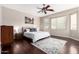 Spacious bedroom with hardwood floors, ceiling fan, and plenty of natural light at 255 W Seagull Pl, Chandler, AZ 85286