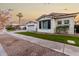 White two-story house with black shutters, palm trees, and a grassy lawn at 255 W Seagull Pl, Chandler, AZ 85286