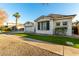 White two-story house with black shutters, palm trees, and a grassy lawn at 255 W Seagull Pl, Chandler, AZ 85286