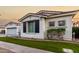 White two-story house with black shutters, palm trees, and a grassy lawn at 255 W Seagull Pl, Chandler, AZ 85286