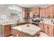 Well-equipped kitchen featuring an island and granite countertops at 255 W Seagull Pl, Chandler, AZ 85286