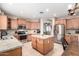 Bright kitchen boasts an island, stainless steel appliances, and granite countertops at 255 W Seagull Pl, Chandler, AZ 85286