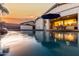 Scenic pool view reflecting the home at sunset, creating a tranquil atmosphere at 255 W Seagull Pl, Chandler, AZ 85286