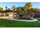 Beautiful kidney-shaped pool with a patio, waterfall and putting green at 255 W Seagull Pl, Chandler, AZ 85286