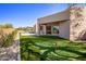 Expansive backyard featuring a putting green, lush landscaping, and desert views for outdoor activities at 25838 N 104Th Pl, Scottsdale, AZ 85255