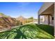 Manicured backyard features a putting green, desert landscaping, mountain views and lush, green lawn at 25838 N 104Th Pl, Scottsdale, AZ 85255