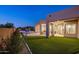 Spacious backyard featuring a pool, outdoor kitchen, dining area, and lush artificial grass at 25838 N 104Th Pl, Scottsdale, AZ 85255