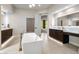 Upscale bathroom with a freestanding tub, double vanities, and elegant lighting at 25838 N 104Th Pl, Scottsdale, AZ 85255