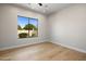 Bright bedroom with hardwood floors, a large window, and neutral paint, offering a serene space at 25838 N 104Th Pl, Scottsdale, AZ 85255