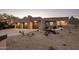 Modern home featuring a three-car garage, desert landscaping, and well-lit entry at 25838 N 104Th Pl, Scottsdale, AZ 85255