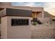 Close-up of the house number on a stone pillar, set against a backdrop of the desert landscape at 25838 N 104Th Pl, Scottsdale, AZ 85255