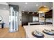 Bright open kitchen featuring marble countertops, stainless steel appliances, and a stylish wine storage unit at 25838 N 104Th Pl, Scottsdale, AZ 85255