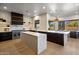 Spacious kitchen featuring a marble island, dark cabinetry, and high-end appliances at 25838 N 104Th Pl, Scottsdale, AZ 85255