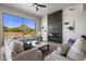 Bright living room with modern fireplace and scenic mountain views at 25838 N 104Th Pl, Scottsdale, AZ 85255