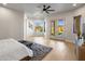 Spacious main bedroom with a ceiling fan, sitting area, and french doors with backyard access at 25838 N 104Th Pl, Scottsdale, AZ 85255