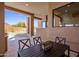 Covered patio featuring an outdoor dining table, chairs, and views of the backyard and surrounding landscape at 25838 N 104Th Pl, Scottsdale, AZ 85255