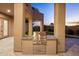 An outdoor kitchen featuring a built-in stainless steel grill with granite countertop nestled in a covered patio at 25838 N 104Th Pl, Scottsdale, AZ 85255