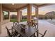 Covered patio with outdoor dining set and putting green view at 25838 N 104Th Pl, Scottsdale, AZ 85255