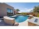 Resort-style pool with fire pit and built-in seating at 25838 N 104Th Pl, Scottsdale, AZ 85255