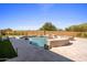 Lush backyard oasis featuring a pool with stone accents, patio, desert landscape and blue skies at 25838 N 104Th Pl, Scottsdale, AZ 85255