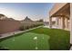 Manicured putting green in the backyard, surrounded by desert landscaping, with mountain views in the distance at 25838 N 104Th Pl, Scottsdale, AZ 85255