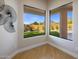 Bright sitting area with floor-to-ceiling windows offering backyard views and wood floors at 25838 N 104Th Pl, Scottsdale, AZ 85255