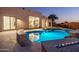 Backyard swimming pool with a fire feature and view of the home's stylish modern design at 25838 N 104Th Pl, Scottsdale, AZ 85255