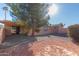 Backyard view showing gravel and a large tree at 26430 S Pinewood Dr, Sun Lakes, AZ 85248