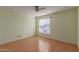 Simple bedroom with wood-look floors and window coverings at 26430 S Pinewood Dr, Sun Lakes, AZ 85248