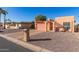 Tan stucco house with a pink garage door and a gravel driveway at 26430 S Pinewood Dr, Sun Lakes, AZ 85248