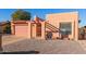 Tan stucco house with a pink garage door and a gravel driveway at 26430 S Pinewood Dr, Sun Lakes, AZ 85248