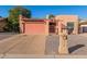 Tan stucco house with a pink garage door and a gravel driveway at 26430 S Pinewood Dr, Sun Lakes, AZ 85248