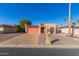 Tan stucco house with a pink garage door and a gravel driveway at 26430 S Pinewood Dr, Sun Lakes, AZ 85248