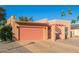 Tan stucco house with a pink garage door and a gravel driveway at 26430 S Pinewood Dr, Sun Lakes, AZ 85248