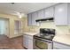 Stainless steel range and overhead microwave in kitchen at 26430 S Pinewood Dr, Sun Lakes, AZ 85248