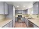 Galley kitchen with stainless steel appliances and light gray cabinets at 26430 S Pinewood Dr, Sun Lakes, AZ 85248