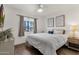 Bedroom with wood-look floors, large window, and neutral decor at 2647 E Evergreen St, Mesa, AZ 85213