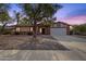 Brick ranch house with a two-car garage and mature landscaping at 2647 E Evergreen St, Mesa, AZ 85213