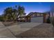 Single story home with attached two-car garage and mature landscaping at 2647 E Evergreen St, Mesa, AZ 85213