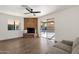 Living room features a brick fireplace, sliding glass door to backyard, and wood-look flooring at 2647 E Evergreen St, Mesa, AZ 85213