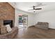 Bright living room with brick fireplace and sliding glass doors to the backyard at 2647 E Evergreen St, Mesa, AZ 85213