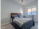 Cozy bedroom with a queen-size bed and natural light at 27648 N 102Nd Ln, Peoria, AZ 85383