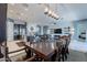 Dining room with a large wooden table and chandelier at 27648 N 102Nd Ln, Peoria, AZ 85383