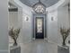 Elegant entryway with chandelier and tile flooring at 27648 N 102Nd Ln, Peoria, AZ 85383