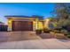 Night view of the home's exterior and landscaping at 27648 N 102Nd Ln, Peoria, AZ 85383